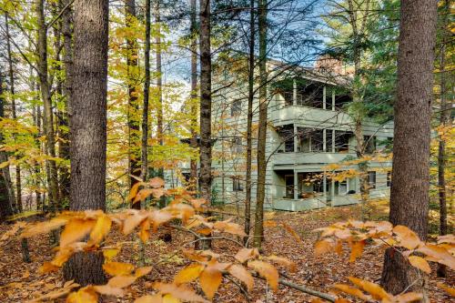 a house in the middle of a forest with leaves at Spacious Bartlett Condo with Balconies and Pool! in Bartlett