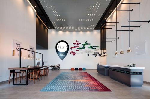 a dining room with a table and a rug at Rove Trade Centre in Dubai