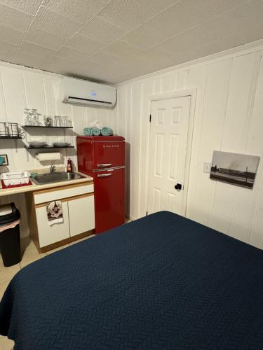 a kitchen with a red refrigerator and a sink at North Beach Motel in Hampton