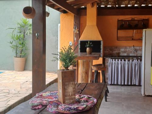 a kitchen with a wooden table with plants on it at BEM ESTAR À BEIRA MAR in Ubatuba