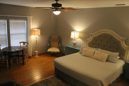 a bedroom with a bed and a table and chairs at Turtle Beach Inn in Indian Pass
