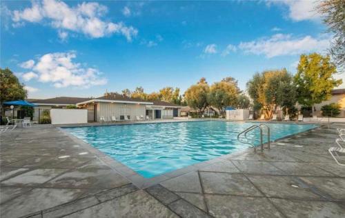 a large swimming pool with blue water at 2 story Casual Cute Condo 6 miles from Disneyland & 8 miles Knotts 2bd 2bth Sleeps 8 plus in Cypress
