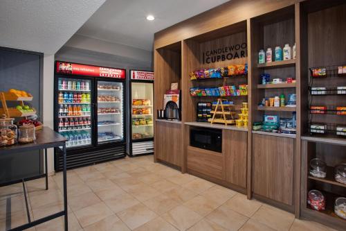 a grocery store aisle with refrigerators and food at Candlewood Suites Kenosha - Pleasant Prairie by IHG in Pleasant Prairie