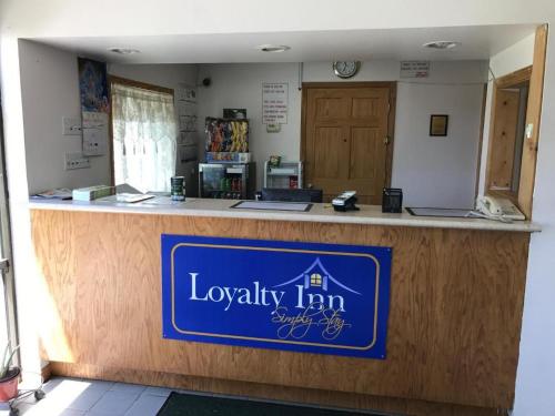 Un mostrador de la posada de lealtad con una señal azul. en Loyalty Inn Maryville, en Maryville