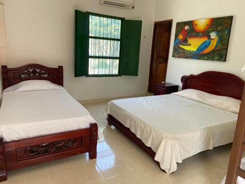 HOTEl CASAFINCA TURBACO EN MOMPOX CON PARQUEADERO tesisinde bir odada yatak veya yataklar