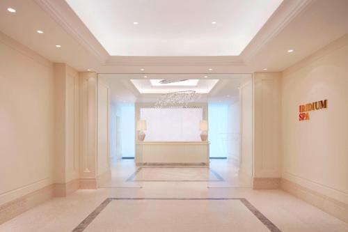 a large hallway with a white wall in a building at The St. Regis Kuala Lumpur in Kuala Lumpur