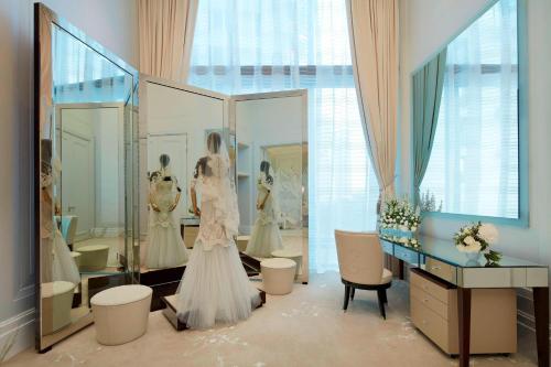 a dressing room with a wedding dress in front of a mirror at The St. Regis Kuala Lumpur in Kuala Lumpur