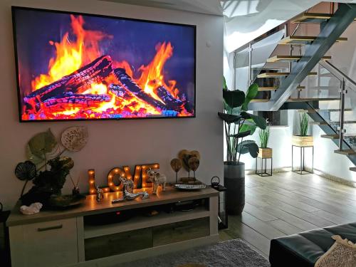 a living room with a fire on the wall at Casa do Penedo Castle House in Linhares