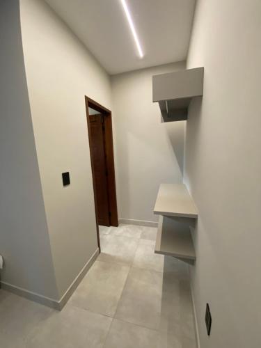 an empty room with a staircase and a door at Nossa suíte - Praia da Pipa in Pipa