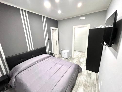 a bedroom with a bed and a flat screen tv at Airport-Napoli in Naples