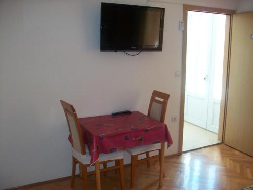 a dining room table with a red table cloth on it at Studio Dominik in Makarska