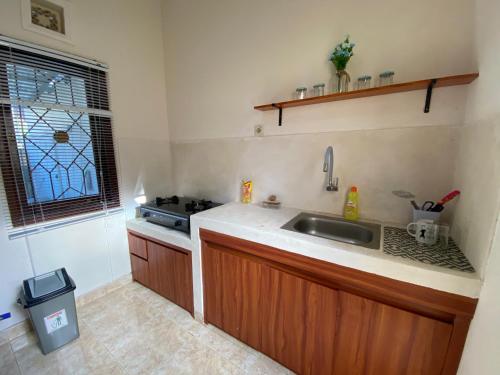 a kitchen with a sink and a stove and a window at GWK View villa style house in Jimbaran