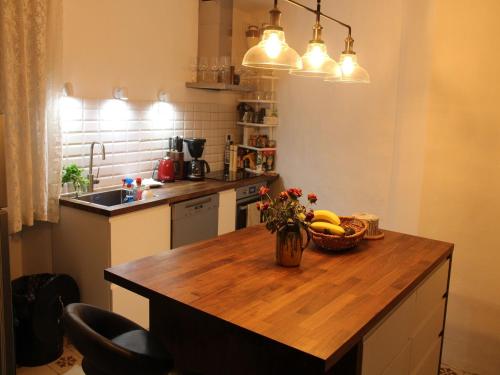 a kitchen with a wooden table with a bowl of fruit at Riverside Villa, Remoulins in Remoulins