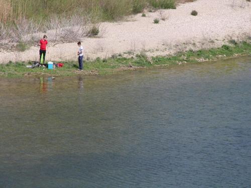 two people standing on the shore of a body of water at Riverside Villa, Remoulins in Remoulins