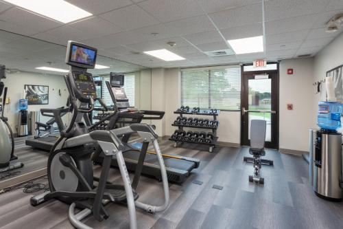 a gym with treadmills and exercise equipment and a television at Staybridge Suites Buffalo by IHG in Buffalo