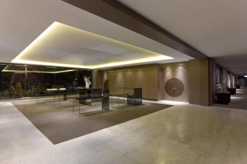 a room with a table and chairs in a building at Le Meridien Taipei in Taipei