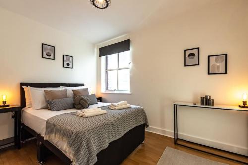 a bedroom with a bed with two towels on it at Marigold- 2 Bedroom, Sleeps 5 in Southampton