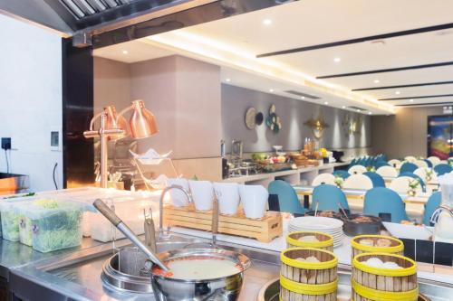 a restaurant with tables and chairs in a room at Real Joy Light in Shenzhen