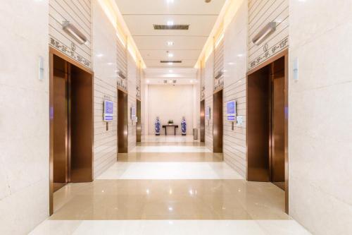 a hallway of a building with doors and a table at Real Joy Light in Shenzhen