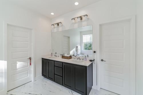 a white bathroom with a sink and a mirror at Valley Getaway 15 mins from Napa 10 min from Suisan valley large backyard with fire pit and more in Fairfield