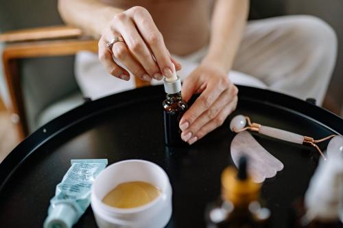 a woman is holding a bottle on a table at Holiday Inn Express Dubai Airport by IHG in Dubai