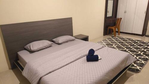 a bed with a blue duck sitting on top of it at SleepRest @ NTC in Nagoya