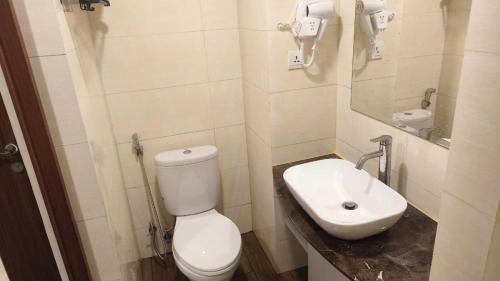 a bathroom with a white toilet and a sink at SleepRest @ NTC in Nagoya