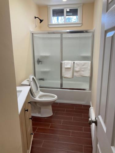 a bathroom with a toilet and a glass shower at Comfortable place to stay in Milford