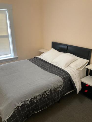 a bedroom with a large bed with white pillows at Comfortable place to stay in Milford