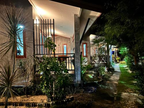 a house with plants in front of it at night at Ibiza Bungalows in Haad Yao