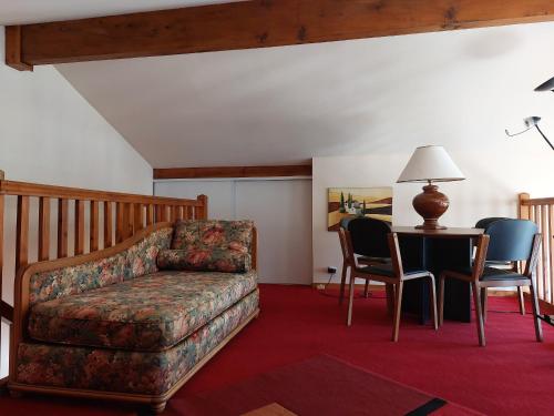 a living room with a couch and a table and chairs at Maison avec jardin, terrasse et parking proche plage - FR-1-239-772 in Urrugne