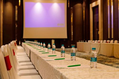 a row of bottles of water sitting on a table at Holiday Inn Chennai OMR IT Expressway by IHG in Chennai