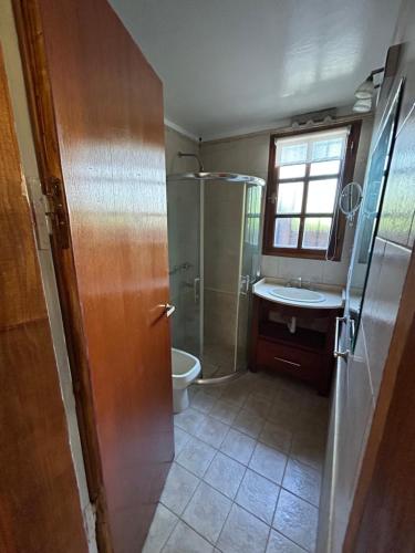 a bathroom with a shower and a toilet and a sink at Casa Quinta en Gonnet in Manuel B. Gonnet