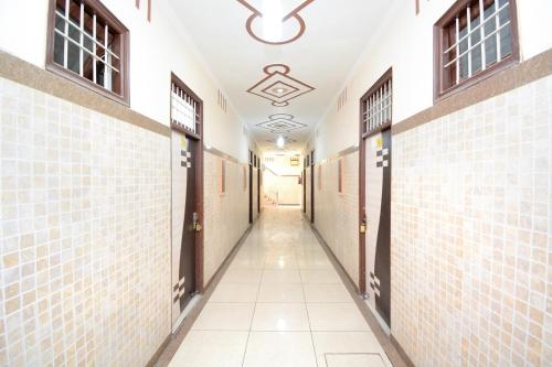 a hallway of a building with doors and tiled walls at OYO Flagship Hotel Divine Light in Bhiwāni
