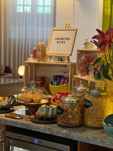 a counter with jars of food on a table at Ann Siang House, The Unlimited Collection managed by The Ascott Limited in Singapore