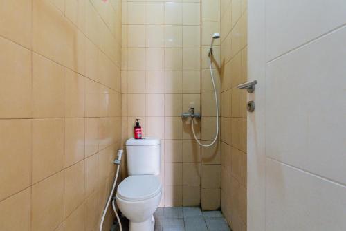 a bathroom with a toilet and a shower at RedDoorz @ Garden Boulevard Citra Raya Tangerang in Tangerang