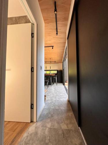 an open hallway with a dining room in a house at Nandina, en el bosque y playa in La Pedrera