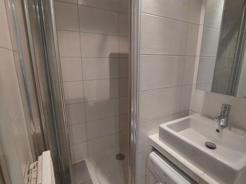 une salle de bain blanche avec une douche et un lavabo dans l'établissement Appartement cosy aux Deux Alpes, au pied des pistes, pour 4 pers, balcon, parking, proche commodités - FR-1-516-211, à Les Deux Alpes