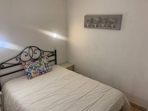 - une petite chambre avec un lit et un oreiller dans l'établissement Charmant T2 climatisé avec terrasse et piscine, proche plages et commerces - FR-1-768-5, aux Issambres