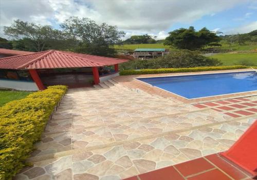 a swimming pool in a yard with a pavilion at Casa Finca Kilometro 28 Bitaco in La Cumbre