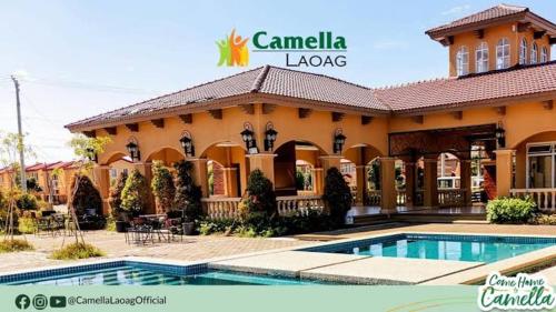 a large building with a pool in front of it at Camella homes laoag city ilocos norte in Bangued