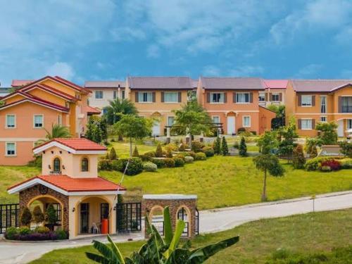 a large apartment building with a lawn and a yard at Camella homes laoag city ilocos norte in Bangued