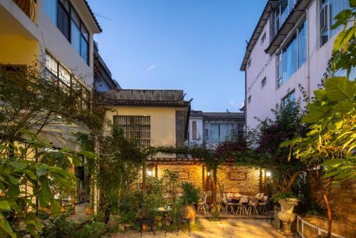 a courtyard with tables and chairs in a building at Dali Garden in Dali