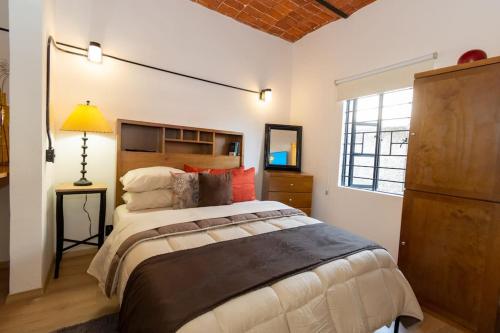 a bedroom with a large bed and a window at Acogedora Suite con Roof Garden en Roma Nte. in Mexico City