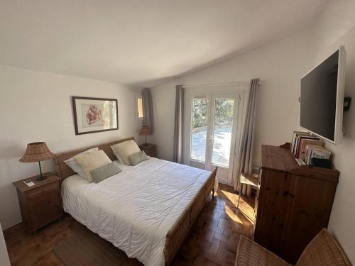 a bedroom with a bed and a large window at Villa provençale avec piscine privée, clim, Wi-Fi, jardin, 5 chambres - FR-1-768-20 in Les Issambres