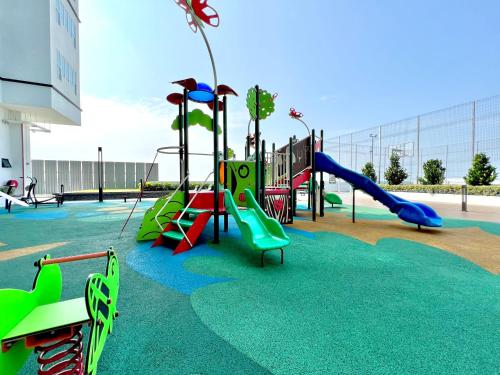 a playground with colorful slides and slidesktop at Melaka AmberCove Homely Seaview 2R2B in Melaka