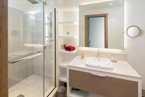 a bathroom with a sink and a shower at LUX APPARTMENT GOLF DE MONT CHOISY in Mont Choisy