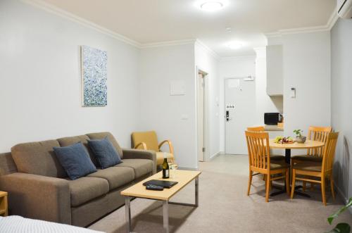 a living room with a couch and a table at Mansfield Apartments in Mansfield