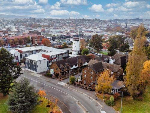 an aerial view of a town with houses and a street at Leisure Inn Penny Royal Hotel & Apartments in Launceston