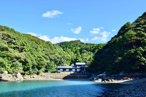 a house on the shore of a river with trees at VILLA Qinglu - Vacation STAY 62076v in Sasebo